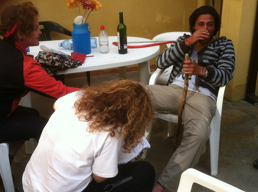 A Gracious Hospitalera working on Santiago's Blisters. Note the Hacksaw in the Background